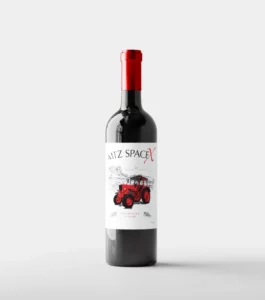 Wine bottle with a red cap and a label featuring a bright red tractor illustration